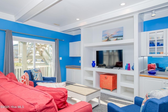 living room featuring built in shelves, beam ceiling, and crown molding