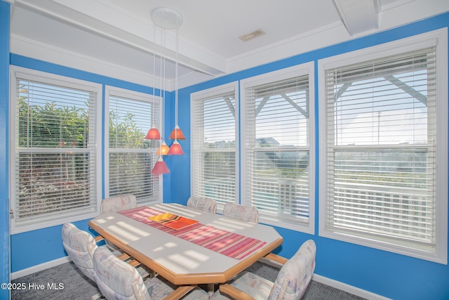 dining room featuring beamed ceiling, carpet floors, and ornamental molding