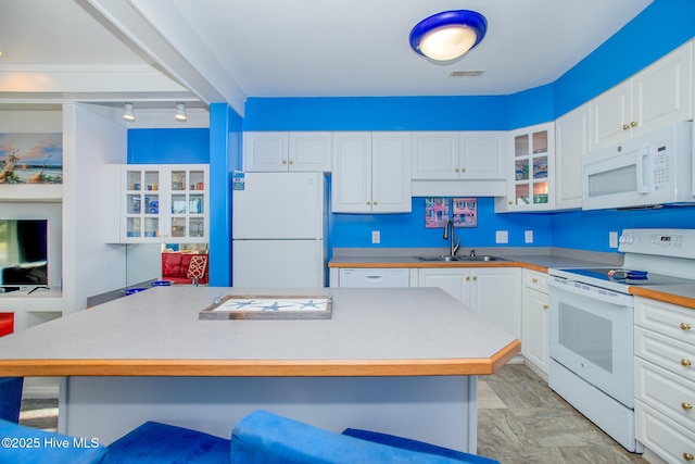 kitchen featuring white cabinets, white appliances, sink, and a breakfast bar area