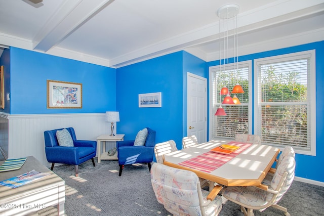 dining space with carpet, beam ceiling, and crown molding