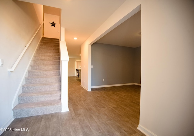 stairway with hardwood / wood-style flooring