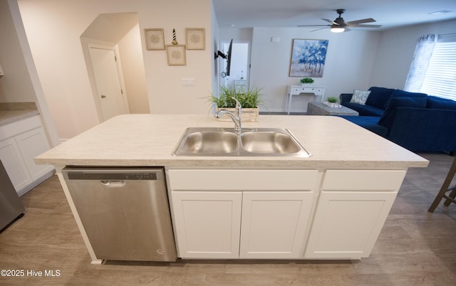 kitchen with white cabinetry, a kitchen island with sink, sink, and stainless steel dishwasher