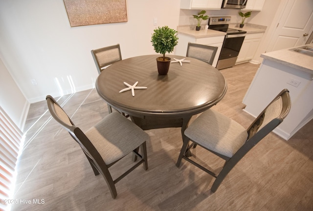 dining area with light hardwood / wood-style flooring