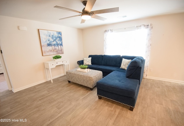 living room featuring light hardwood / wood-style flooring and ceiling fan