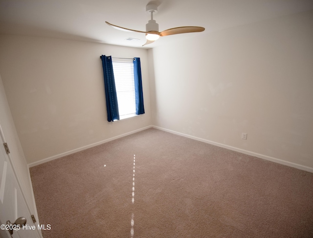 carpeted spare room with ceiling fan