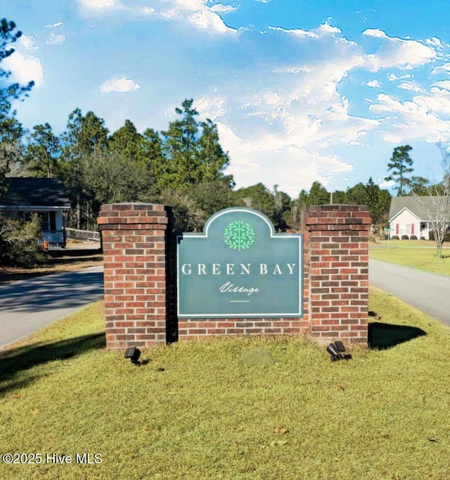 community / neighborhood sign with a lawn