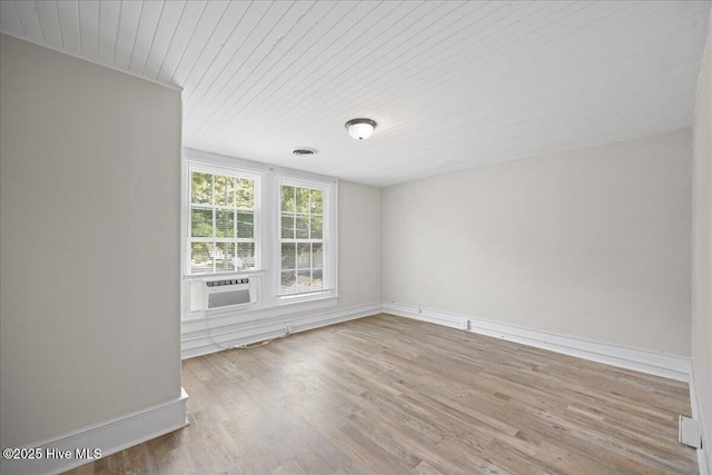 spare room with cooling unit and light wood-type flooring