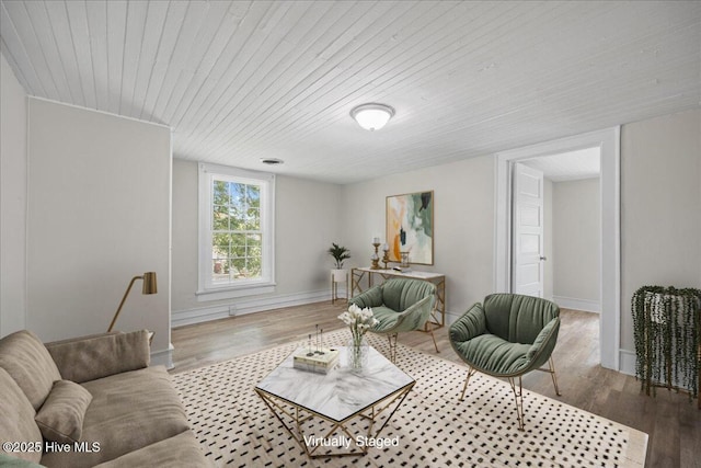 living room with wooden ceiling and hardwood / wood-style flooring