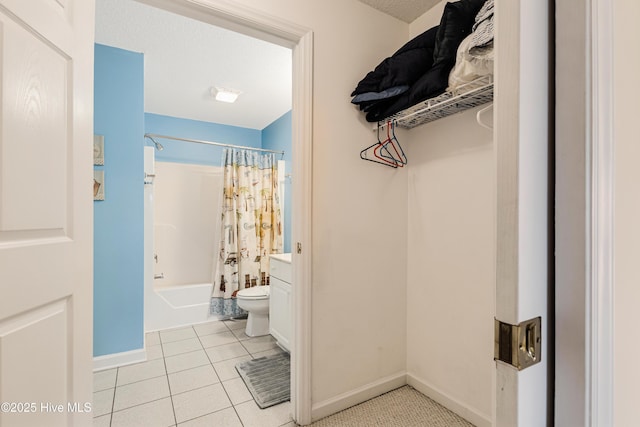 full bathroom featuring tile patterned floors, a textured ceiling, toilet, vanity, and shower / tub combo