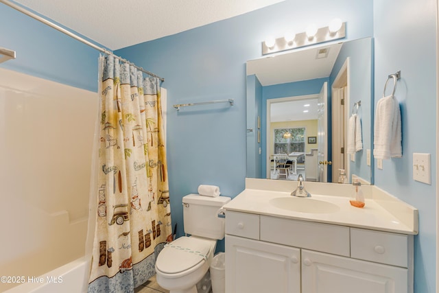 full bathroom featuring shower / bath combo, vanity, and toilet