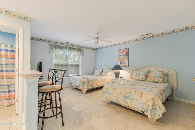 bedroom featuring ceiling fan and light carpet