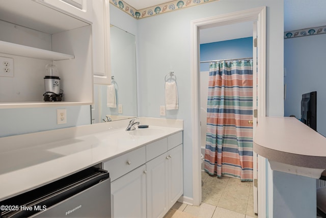 bathroom with tile patterned floors, vanity, and a shower with shower curtain