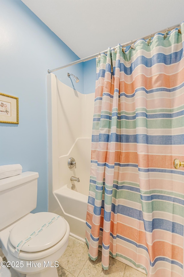 bathroom with tile patterned flooring, shower / tub combo, and toilet