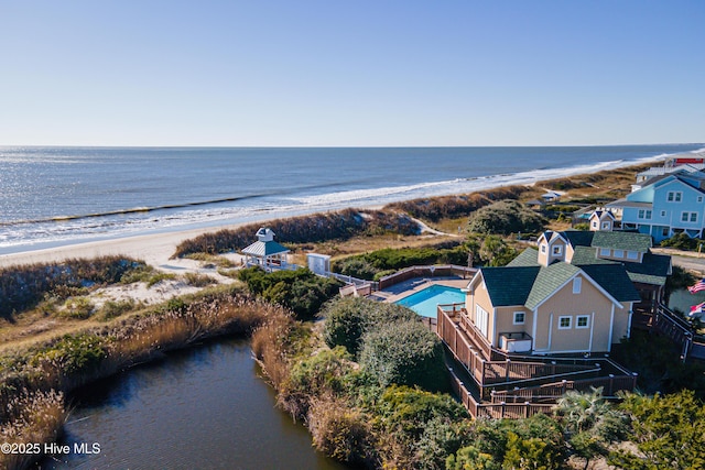 drone / aerial view featuring a water view and a view of the beach