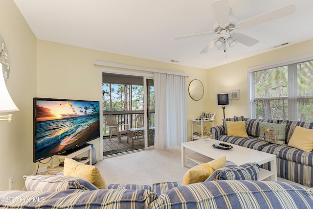 living room featuring carpet flooring and ceiling fan