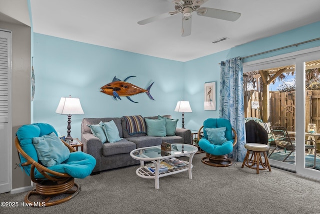 carpeted living room with ceiling fan