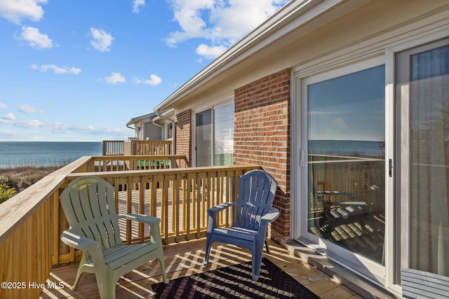 balcony featuring a deck with water view