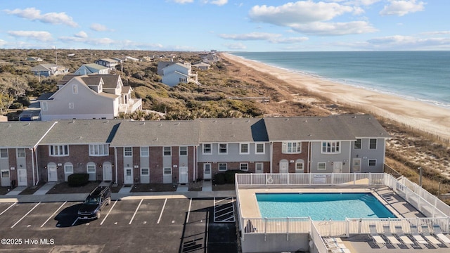 drone / aerial view with a beach view and a water view