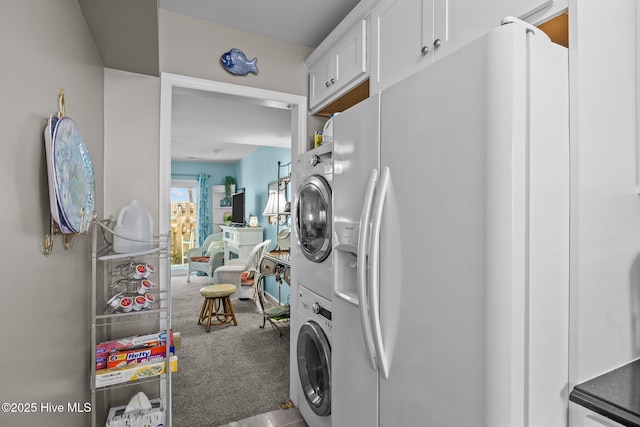 washroom featuring stacked washer / drying machine and carpet flooring