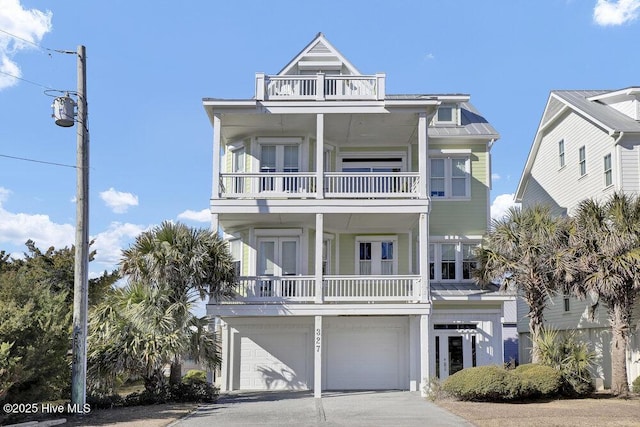 coastal inspired home with a balcony and a garage