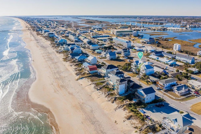 birds eye view of property with a water view and a view of the beach