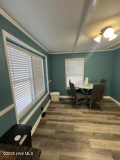 dining area with hardwood / wood-style floors and ornamental molding