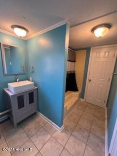 bathroom with a shower, vanity, tile patterned floors, and ornamental molding