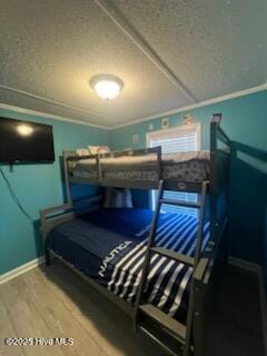 bedroom with a textured ceiling and hardwood / wood-style flooring