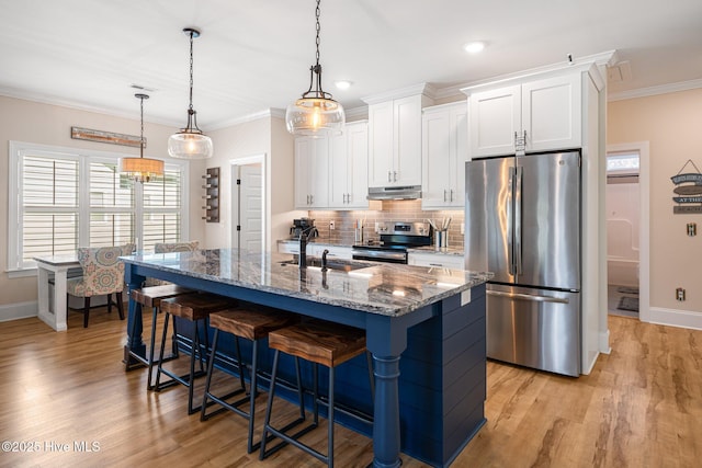 kitchen with white cabinetry, stainless steel appliances, sink, and a center island with sink