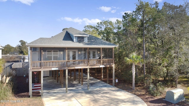 beach home featuring a carport and a sunroom