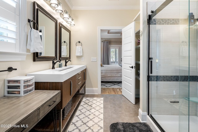 bathroom with tile patterned floors, ornamental molding, an enclosed shower, and vanity