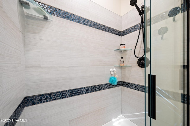 bathroom featuring a shower with shower door