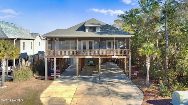 beach home featuring a carport and a sunroom