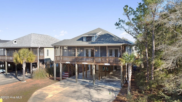 coastal home featuring a carport and a sunroom