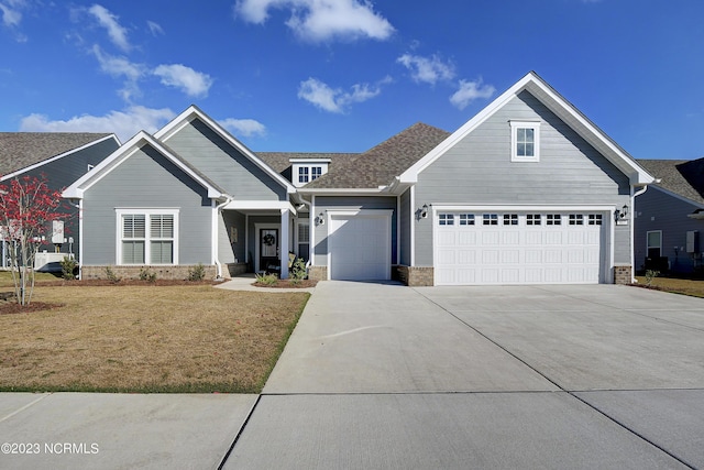 view of front of house featuring a front yard and a garage