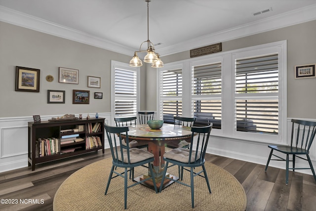 dining area with a chandelier, crown molding, a healthy amount of sunlight, and dark hardwood / wood-style floors