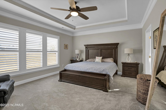 bedroom with light carpet, a raised ceiling, ceiling fan, and crown molding