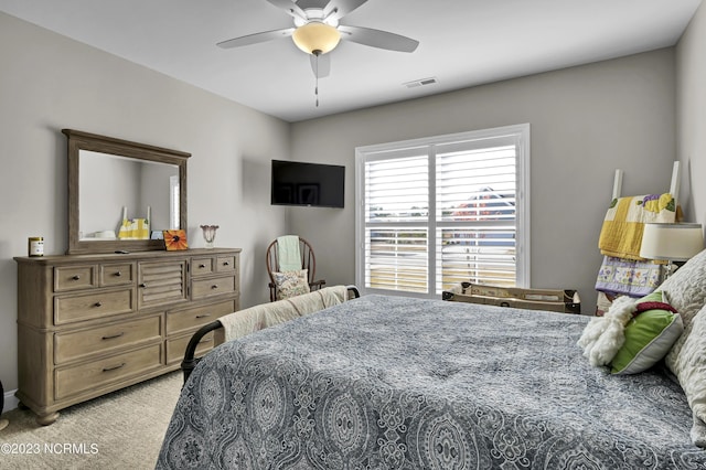 bedroom with ceiling fan and light colored carpet