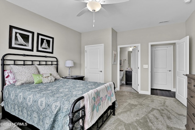 bedroom with carpet, ceiling fan, and ensuite bath