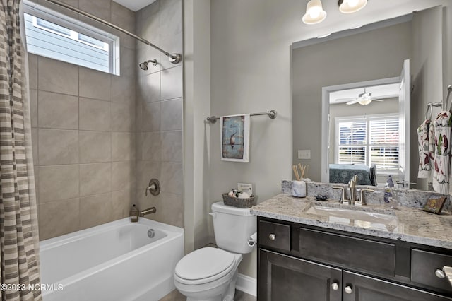 full bathroom featuring vanity, ceiling fan, toilet, and shower / tub combo