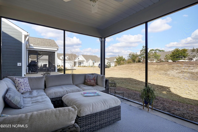 sunroom / solarium featuring ceiling fan