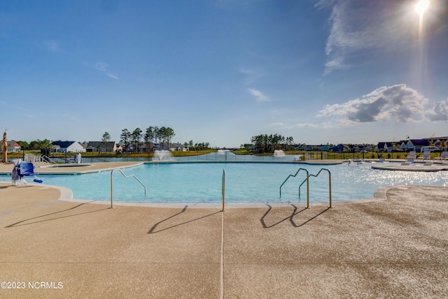 view of pool with pool water feature and a patio area