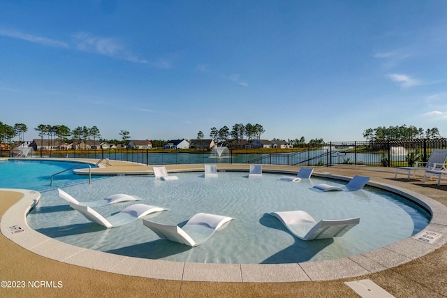 view of swimming pool featuring pool water feature and a patio area