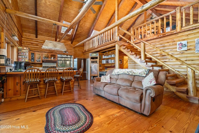 living room featuring wood ceiling, wood-type flooring, beam ceiling, high vaulted ceiling, and bar