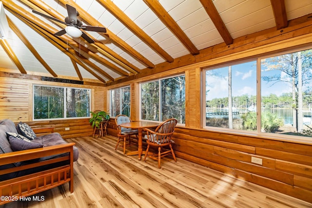 sunroom / solarium with lofted ceiling with beams, a water view, and ceiling fan