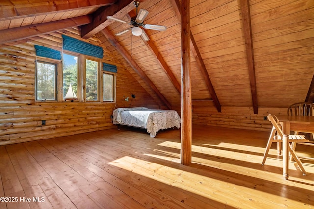 unfurnished bedroom with light wood-type flooring, lofted ceiling with beams, rustic walls, and wood ceiling