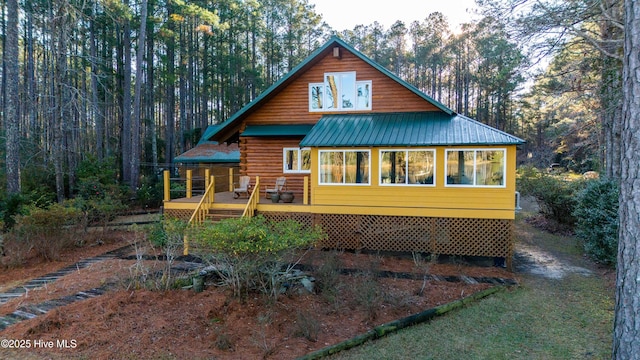 rear view of house with a wooden deck