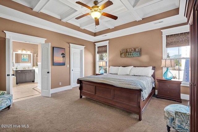 carpeted bedroom with ensuite bathroom, multiple windows, beam ceiling, ceiling fan, and coffered ceiling