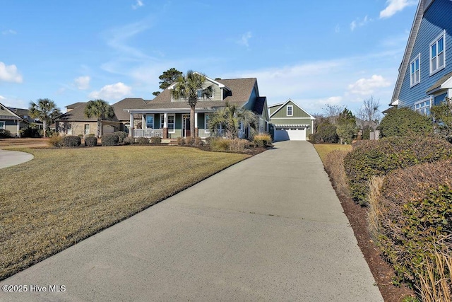 view of front of property featuring a front yard, a garage, and a porch