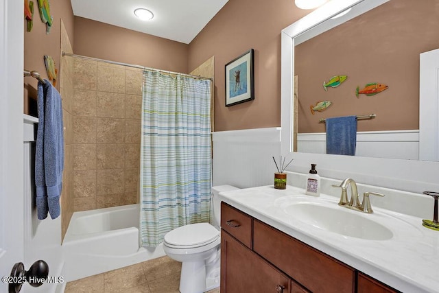 full bathroom with tile patterned floors, shower / tub combo with curtain, vanity, and toilet